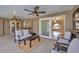Covered patio with seating area, ceiling fans, and sliding glass doors leading to the interior at 1890 Wateroak W Dr, Clearwater, FL 33764