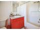 Bathroom featuring a shower, sink, and red vanity at 2009 153Rd E Ct, Bradenton, FL 34212
