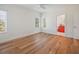 An empty bedroom featuring hardwood floors, two windows, and an en suite bathroom at 2009 153Rd E Ct, Bradenton, FL 34212