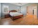 Serene bedroom with wood floors, neutral tones, and ample natural light from the windows at 2009 153Rd E Ct, Bradenton, FL 34212