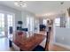 Bright dining room featuring wood floors, a large dining table, and access to the outdoors at 2009 153Rd E Ct, Bradenton, FL 34212
