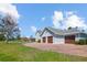 Charming home exterior featuring a three-car garage, brick driveway, and well-manicured lawn at 2009 153Rd E Ct, Bradenton, FL 34212