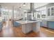 Modern kitchen featuring a large island, stainless steel appliances, and hardwood floors at 2009 153Rd E Ct, Bradenton, FL 34212