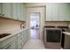 Spacious laundry room with sink, counter space, and newer washer and dryer units for convenience at 2009 153Rd E Ct, Bradenton, FL 34212
