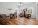 Living room with hardwood floors, ceiling fan, a desk, and two arm chairs at 2009 153Rd E Ct, Bradenton, FL 34212