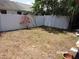 Backyard with a white fence and privacy landscaping with lush green trees and plants at 2025 Dover Ct, Oldsmar, FL 34677