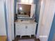 Elegant bathroom featuring a vanity with marble countertop, a large mirror, and white cabinets at 2025 Dover Ct, Oldsmar, FL 34677