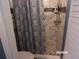 Updated bathroom featuring tiled walls, neutral colors and a patterned shower curtain at 2025 Dover Ct, Oldsmar, FL 34677