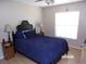 Cozy bedroom with a comfortable bed, lamps, and natural light from the bright window at 2025 Dover Ct, Oldsmar, FL 34677