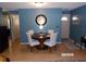 Cozy dining room with a round table, white chairs, and a decorative clock on the wall at 2025 Dover Ct, Oldsmar, FL 34677