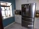 Modern kitchen with stainless steel appliances, white cabinets, and a bright window at 2025 Dover Ct, Oldsmar, FL 34677