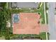 Aerial view of home showcasing roof, screened-in pool, and surrounding landscaping and neighborhood at 2142 Scarlet Oaks St, Clearwater, FL 33759