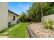 Spacious backyard with lush grass, stone pathway, and tropical landscaping, creating a serene outdoor space at 2142 Scarlet Oaks St, Clearwater, FL 33759