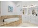 Bright bathroom featuring a soaking tub with stone surround and dual sink vanity at 2142 Scarlet Oaks St, Clearwater, FL 33759