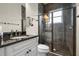 Bathroom features dark tile and a glass enclosed shower at 2142 Scarlet Oaks St, Clearwater, FL 33759