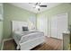 Cozy bedroom with light green walls and a well-lit ceiling fan at 2142 Scarlet Oaks St, Clearwater, FL 33759