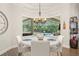 Bright breakfast nook with backyard pool views through a large window and comfortable seating at 2142 Scarlet Oaks St, Clearwater, FL 33759