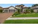 Beautiful home with a brick driveway, lush lawn, and manicured landscaping at 2142 Scarlet Oaks St, Clearwater, FL 33759