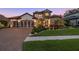 Stunning home with a paved driveway, manicured lawn, and elegant landscaping, showcasing curb appeal at 2142 Scarlet Oaks St, Clearwater, FL 33759