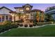 Elegant home with stone accents, manicured landscaping, and a paver walkway leading to a welcoming entrance at 2142 Scarlet Oaks St, Clearwater, FL 33759