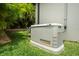 Home generator with palm tree backdrop, ensuring peace of mind during power outages at 2142 Scarlet Oaks St, Clearwater, FL 33759