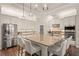Island kitchen featuring stainless steel appliances, granite countertops, a breakfast bar, and a walk-in pantry at 2142 Scarlet Oaks St, Clearwater, FL 33759