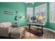 Bright home office with a sit/stand desk, comfortable seating, and bright windows with shutter shades at 2142 Scarlet Oaks St, Clearwater, FL 33759