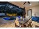Covered outdoor dining area with a view of the pool and tropical landscaping at 2142 Scarlet Oaks St, Clearwater, FL 33759