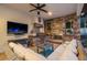 Covered outdoor living space featuring a stone fireplace, grill, and comfortable seating area at 2142 Scarlet Oaks St, Clearwater, FL 33759