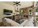 Outdoor living area with a cozy fireplace, TV, and seating at 2142 Scarlet Oaks St, Clearwater, FL 33759