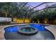 Captivating pool with a hot tub and water fountains, surrounded by greenery and a screen enclosure at 2142 Scarlet Oaks St, Clearwater, FL 33759