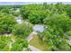 Aerial perspective of the home nestled among mature trees in a quiet neighborhood at 23739 Forest View Dr, Land O Lakes, FL 34639