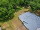 An aerial view of the home's roof, fenced yard, and surrounding lush trees at 23739 Forest View Dr, Land O Lakes, FL 34639