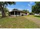 Large backyard with a well-maintained lawn and a view of the screened patio at 23739 Forest View Dr, Land O Lakes, FL 34639