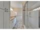 Elegant bathroom featuring granite countertops, double sinks, and a glass-enclosed shower with tiled surround at 23739 Forest View Dr, Land O Lakes, FL 34639
