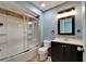 Bathroom featuring a shower-tub combo with sliding glass door, vanity and framed mirror at 23739 Forest View Dr, Land O Lakes, FL 34639