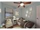 Comfortable bedroom featuring a cozy daybed, ceiling fan, and natural light at 23739 Forest View Dr, Land O Lakes, FL 34639