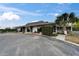Exterior view of a community clubhouse with stone accents and ample parking at 23739 Forest View Dr, Land O Lakes, FL 34639