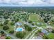 Aerial shot of a vibrant community featuring tennis courts, a running track, a pool, and lush landscaping at 23739 Forest View Dr, Land O Lakes, FL 34639