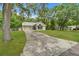 Attractive single-story home with lush landscaping, long driveway, and inviting front entrance at 23739 Forest View Dr, Land O Lakes, FL 34639