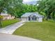 Charming single-story home with a well-maintained lawn and a single-car garage at 23739 Forest View Dr, Land O Lakes, FL 34639