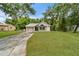 Inviting single-story home featuring a well-kept lawn, attached garage, and cozy curb appeal at 23739 Forest View Dr, Land O Lakes, FL 34639