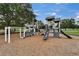 Community playground with slides, climbing structures, and wood chip ground at 23739 Forest View Dr, Land O Lakes, FL 34639