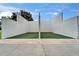Outdoor racquetball court with white concrete walls and green playing surface at 23739 Forest View Dr, Land O Lakes, FL 34639