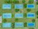 Aerial view of well-maintained community tennis courts surrounded by lush green landscaping and mature trees at 23739 Forest View Dr, Land O Lakes, FL 34639