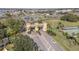 A beautiful aerial view of the community entrance with lush landscaping and well maintained streets at 2413 Oxford Down Ct # 58, Sun City Center, FL 33573
