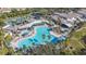 Aerial view of a community pool with umbrellas and lounge chairs at 2413 Oxford Down Ct # 58, Sun City Center, FL 33573
