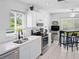 Modern kitchen featuring bright lighting, stainless steel appliances and an adjacent breakfast nook at 2413 Oxford Down Ct # 58, Sun City Center, FL 33573