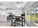 Bright kitchen with white cabinets, stainless steel appliances, and a cozy dining area with views of the outdoors at 2413 Oxford Down Ct # 58, Sun City Center, FL 33573