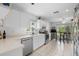 Bright and open kitchen featuring white cabinetry, stainless steel appliances and an adjacent eat-in area at 2413 Oxford Down Ct # 58, Sun City Center, FL 33573